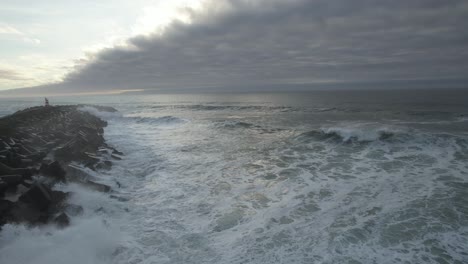 huge storm waves crashing to the pier