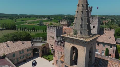 man exiting car at château de pouzilhac courtyard - aerial