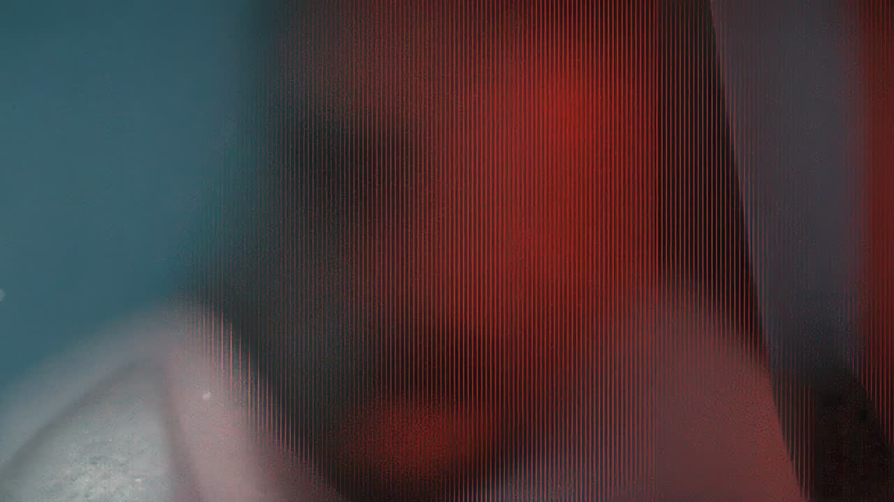 Shifting vertical banded field sliding across lit display, camera panning teal growing red waning