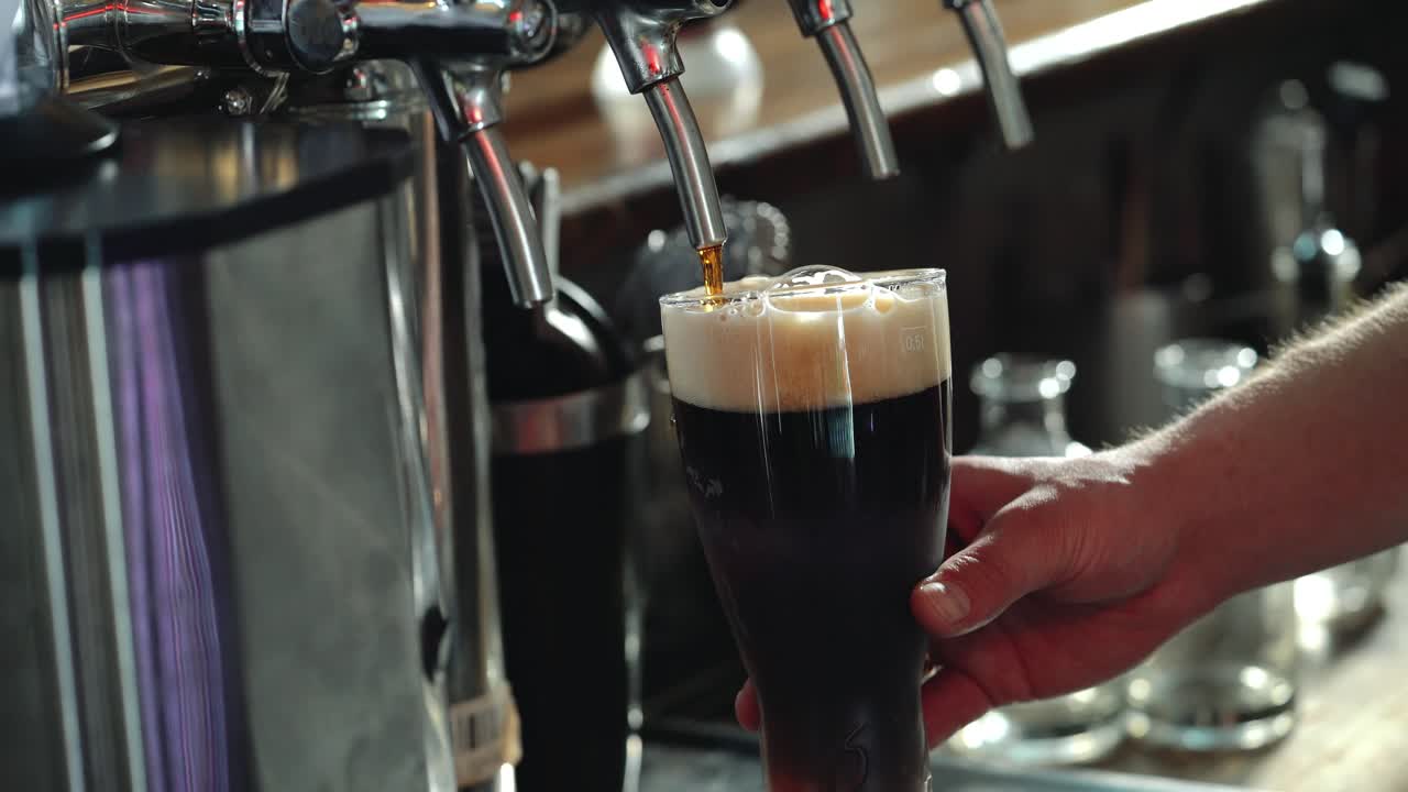 Bartender Pouring Glass of Stout Beer.