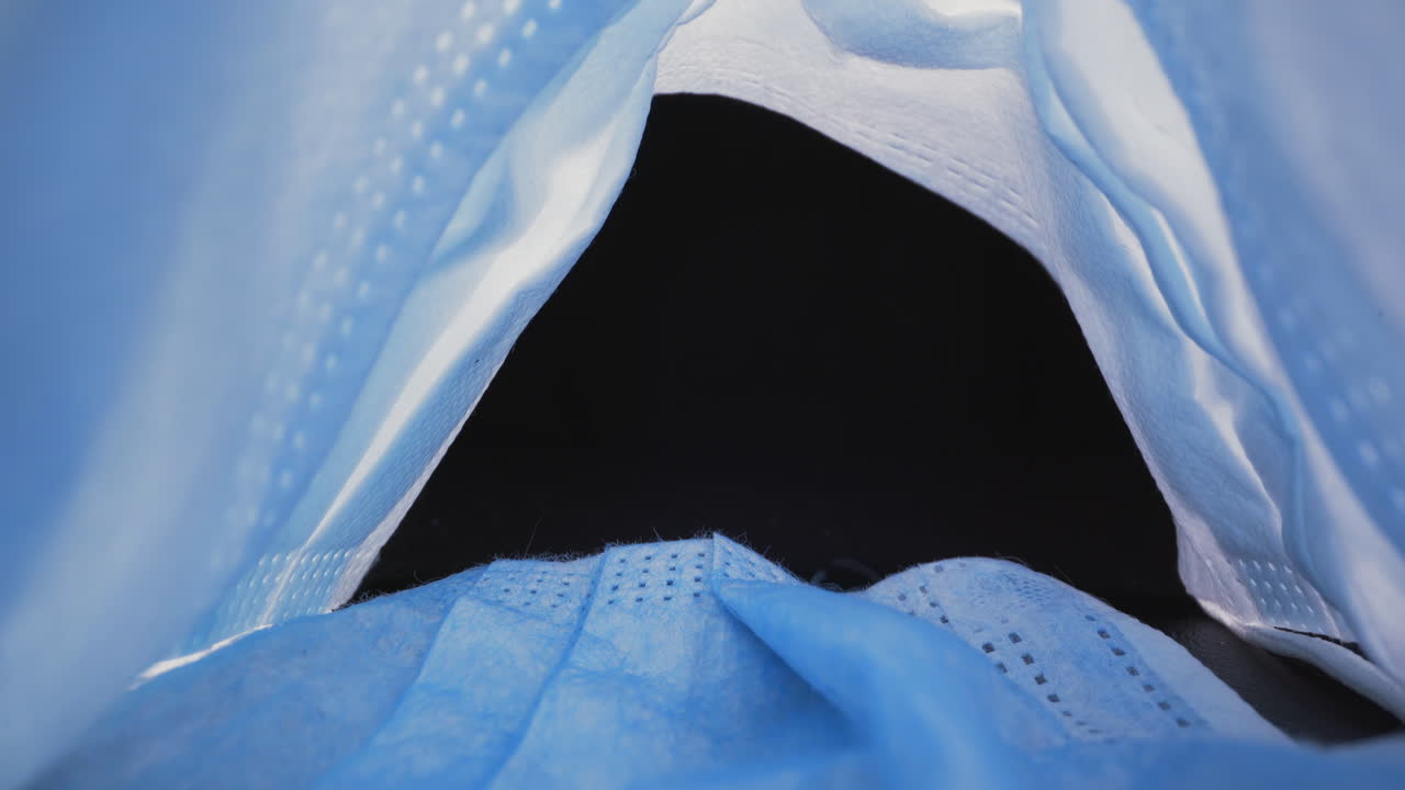 파란색 보호 수술 마스크에서 검은색으로 움직입니다.