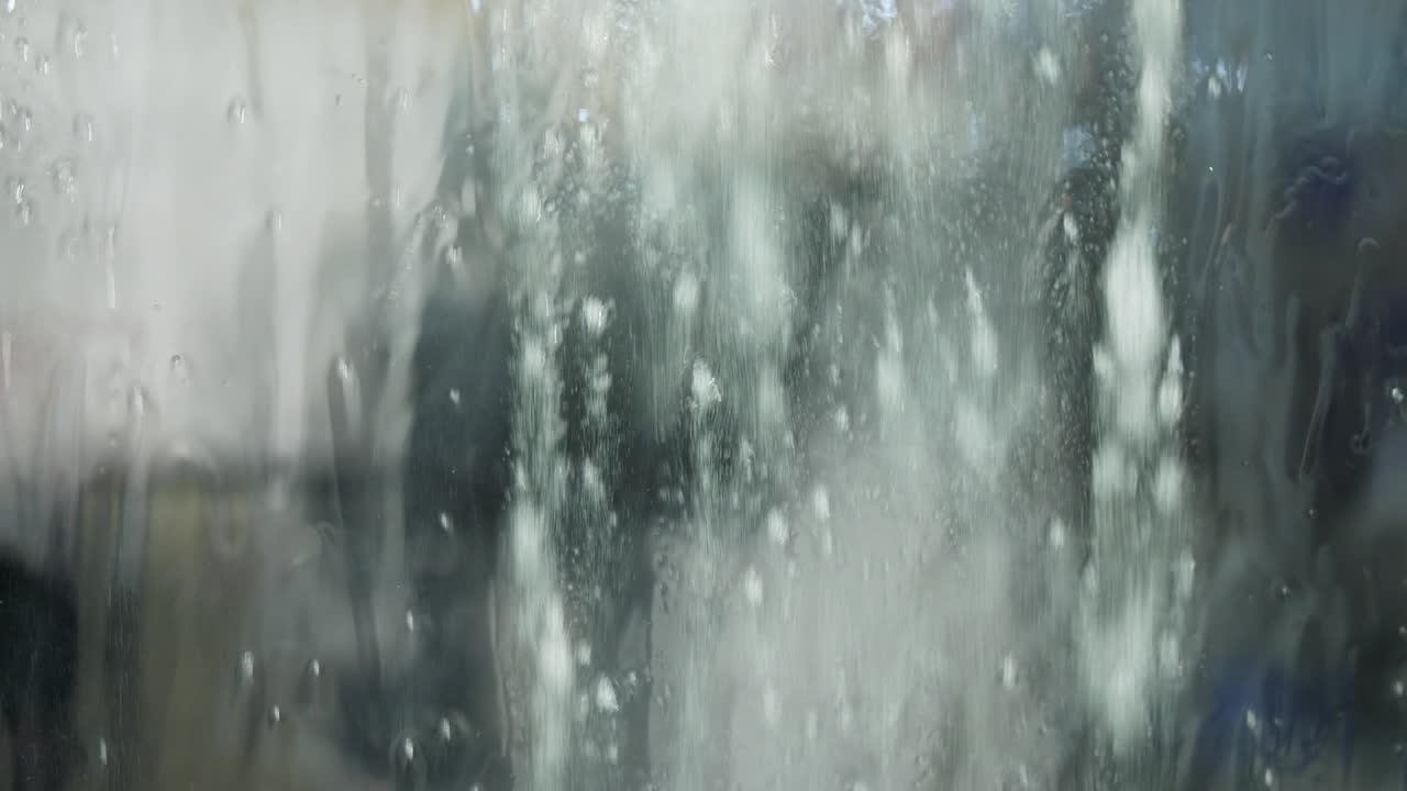 Foam flowing on glass of washing machine