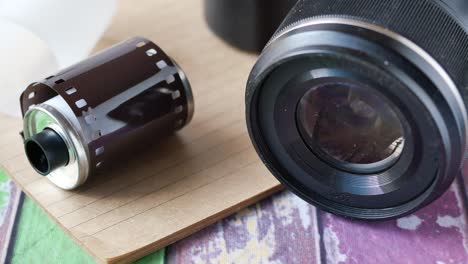 camera with film rolls on table