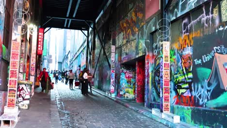 people exploring colorful graffiti-covered alleyway