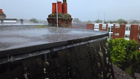 heavy rain downpour on a flat residential roof