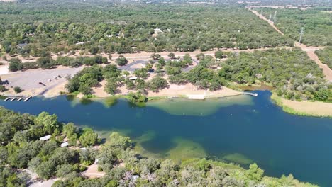 moving to the left high above a narrowing inlet for a park on a lake