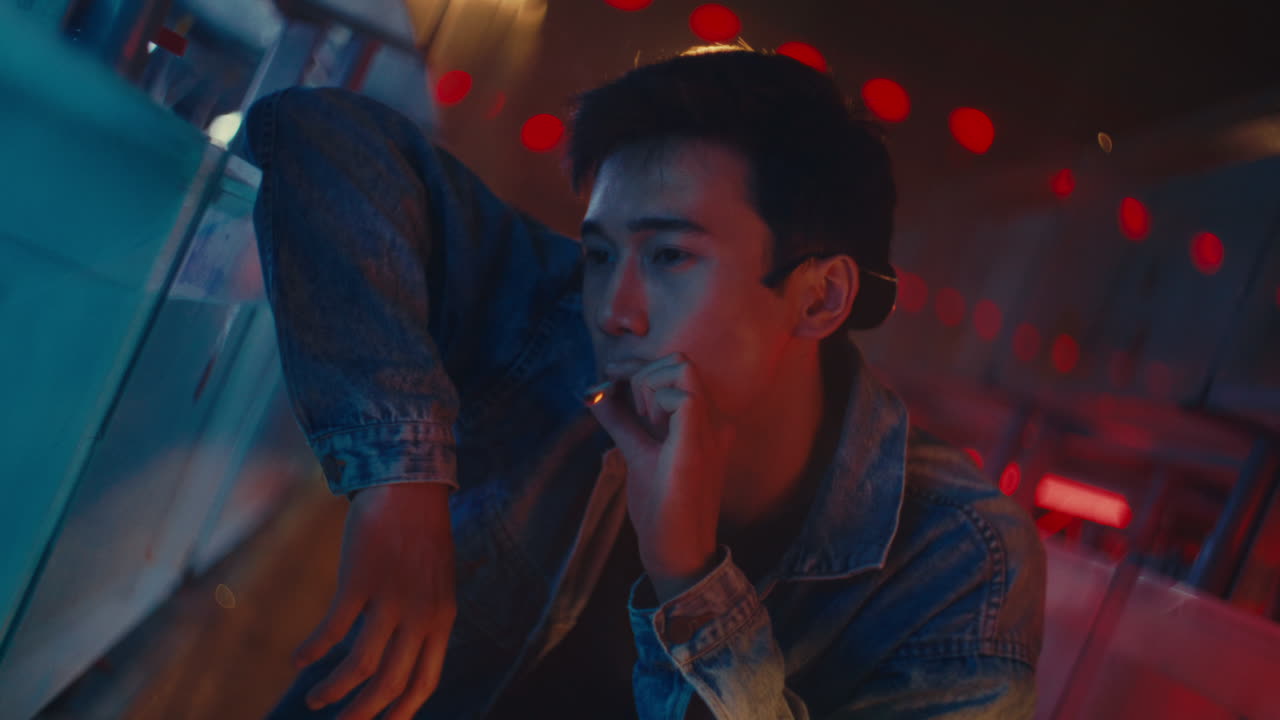 Young Man Smoking at Night