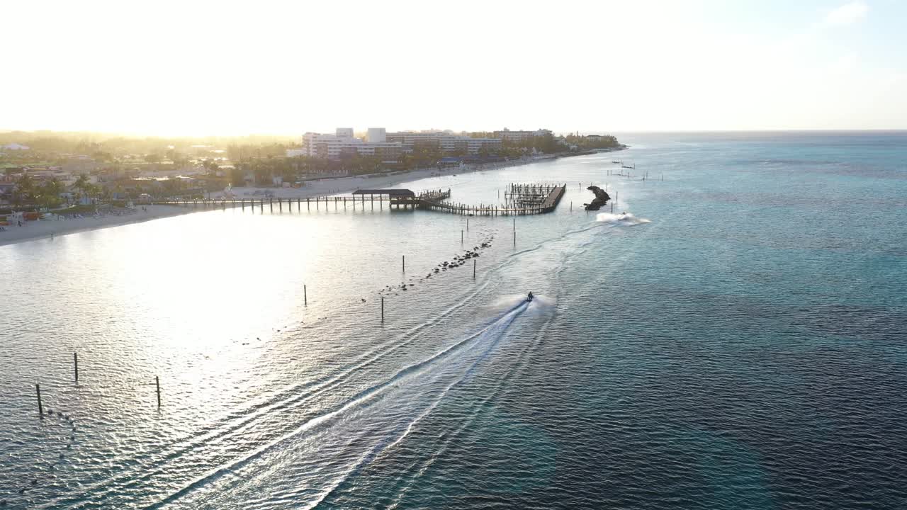 Jet Ski Sailing by Pier in Nassau, Bahamas. Drone Aerial View of Watercrafts Under Sunset Sunlight