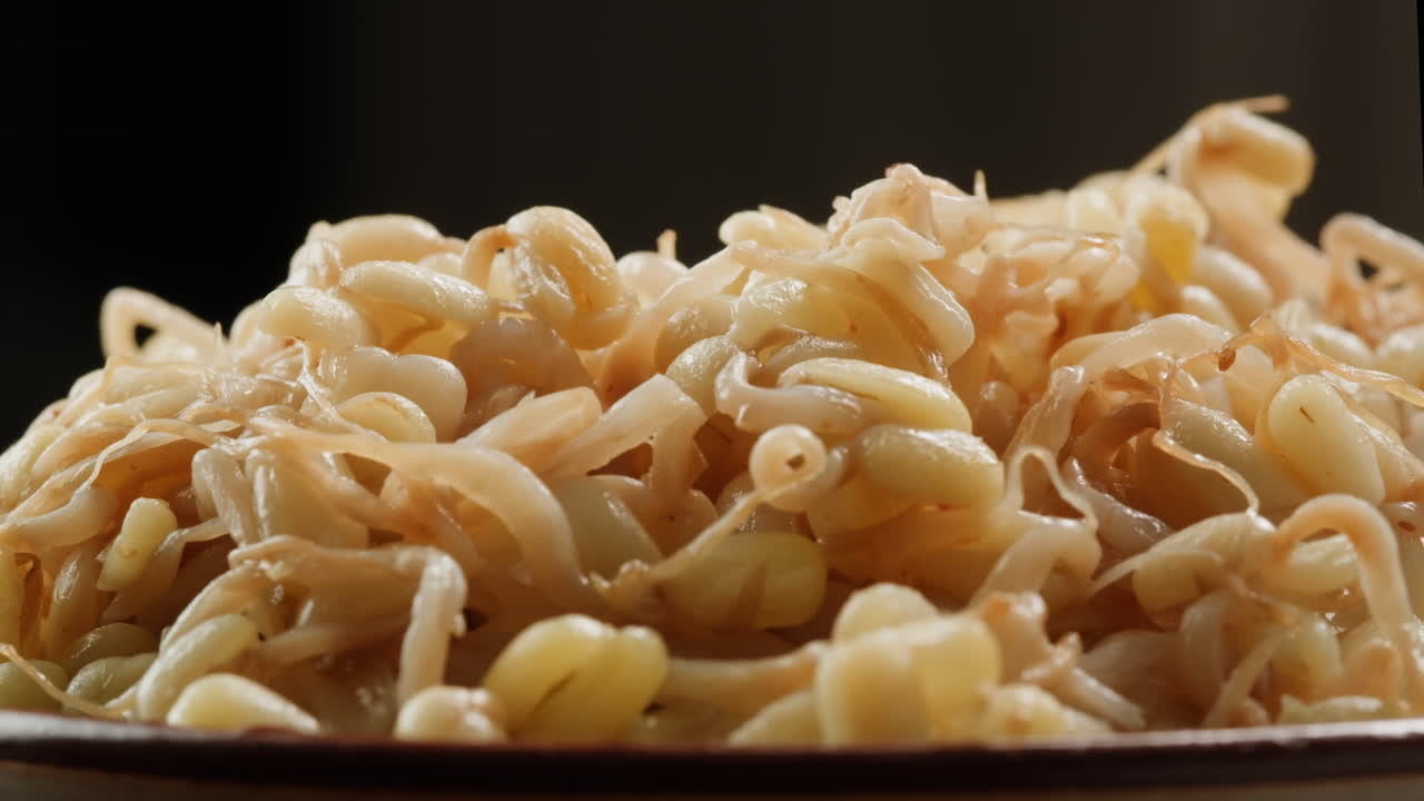 Salted soybean fermented in jar, chinese soy production, marinated food, germinated soy close up in cafe restaurant.