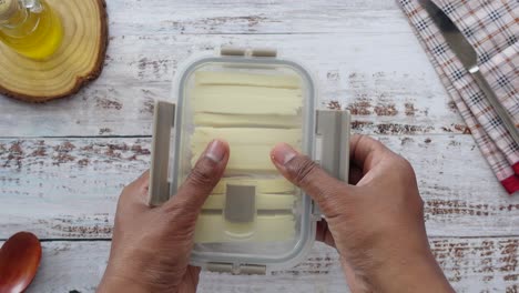 sliced cheese in a transparent container