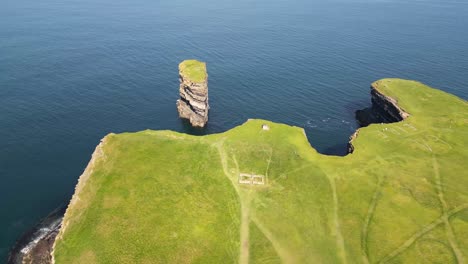 drone shot flying around downpatrick head from left to right showing the 64 eire sign