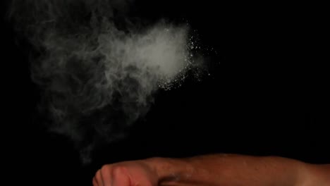 hand punching maize bag on black background