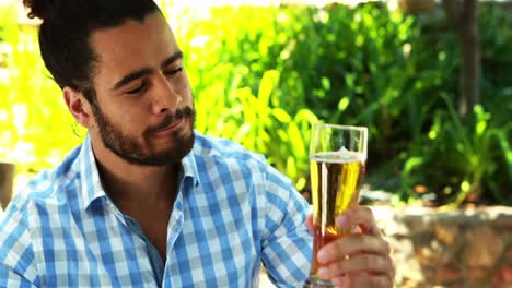 Man-having-glass-of-beer-in-outdoor-restaurant-4k