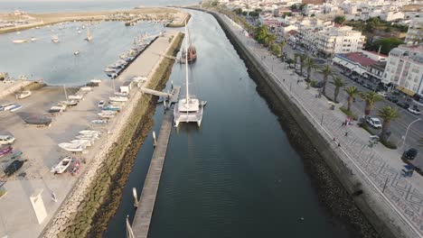 Luxury-yacht-moored-at-pier-in-Bensafrim-river,-Lagos,-Algarve