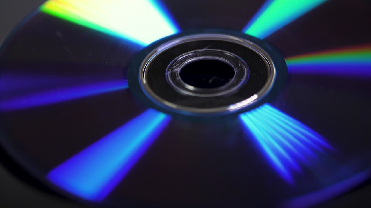 Background of compact disks or dvds. Glare of light on the disk DVD , beautiful colored glare from the light, the background disk DVD