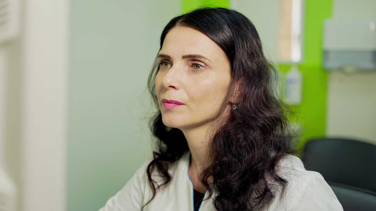 Portrait of female doctor. Woman specialist works in the hospital. Professional doctor sitting in cabinet. Medical concept.