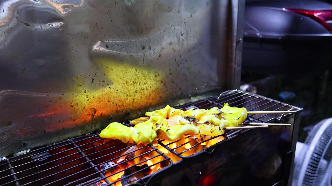 Grilled squid being prepared over open flames