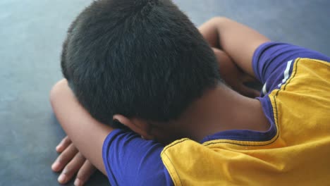 teenage boy head down on desk