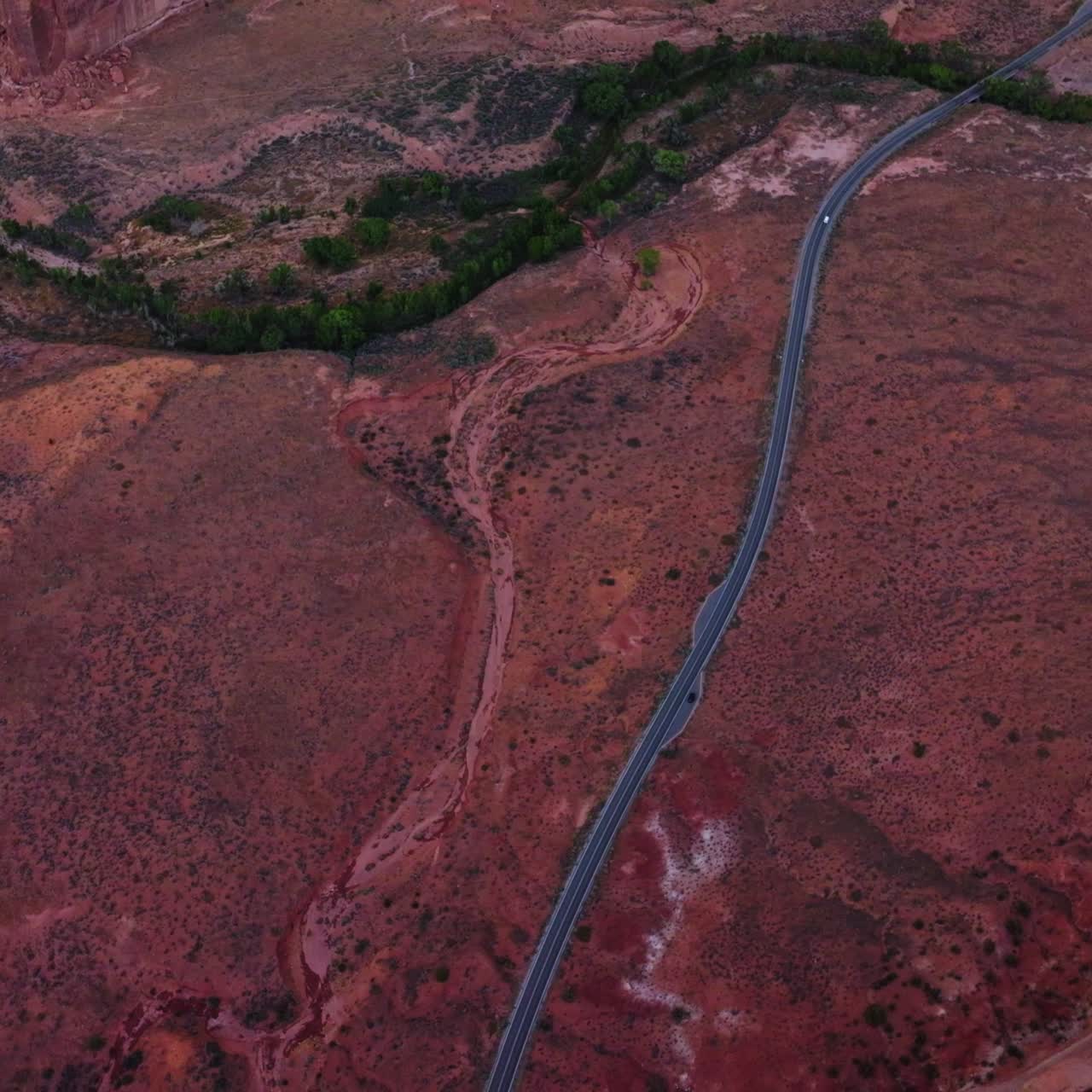 Following the highway going through the desert plain among the canyons. Zion National park in Utah, USA. Aerial perspective