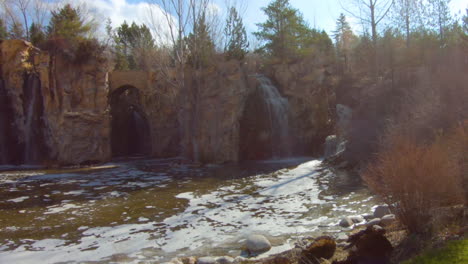 Dolly-shot-passing-a-senior-woman-as-she-gazes-at-a-waterfall-scene