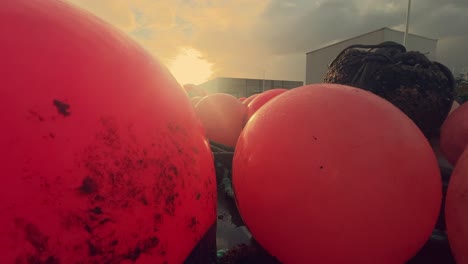 bright red buoys embellish the docks of a scenic spanish fishing village, firmly secured to the coastal jetty, providing a glimpse into the charm of this cozy harbor and its fishing community