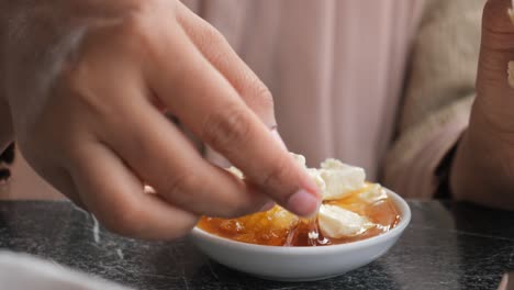 woman enjoying honey, bread and cheese