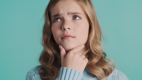 teenage caucasian girl thinking in front of the camera.