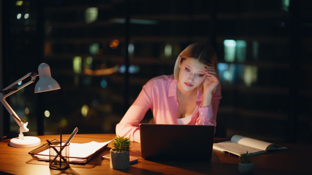 Woman working late at night on a laptop