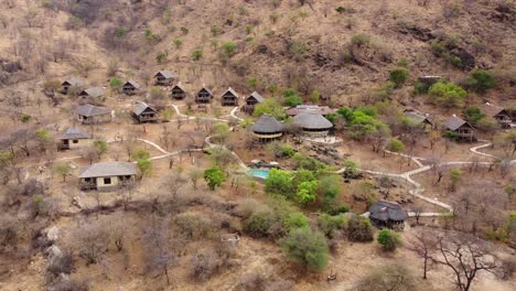 a stunning drone shot of a luxury lodge with swimming pool overlooking the impressive tarangire national park in tanzania in africa