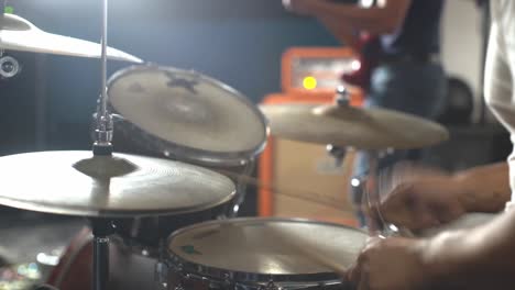 person beating drums to rhythm at concert, close up view