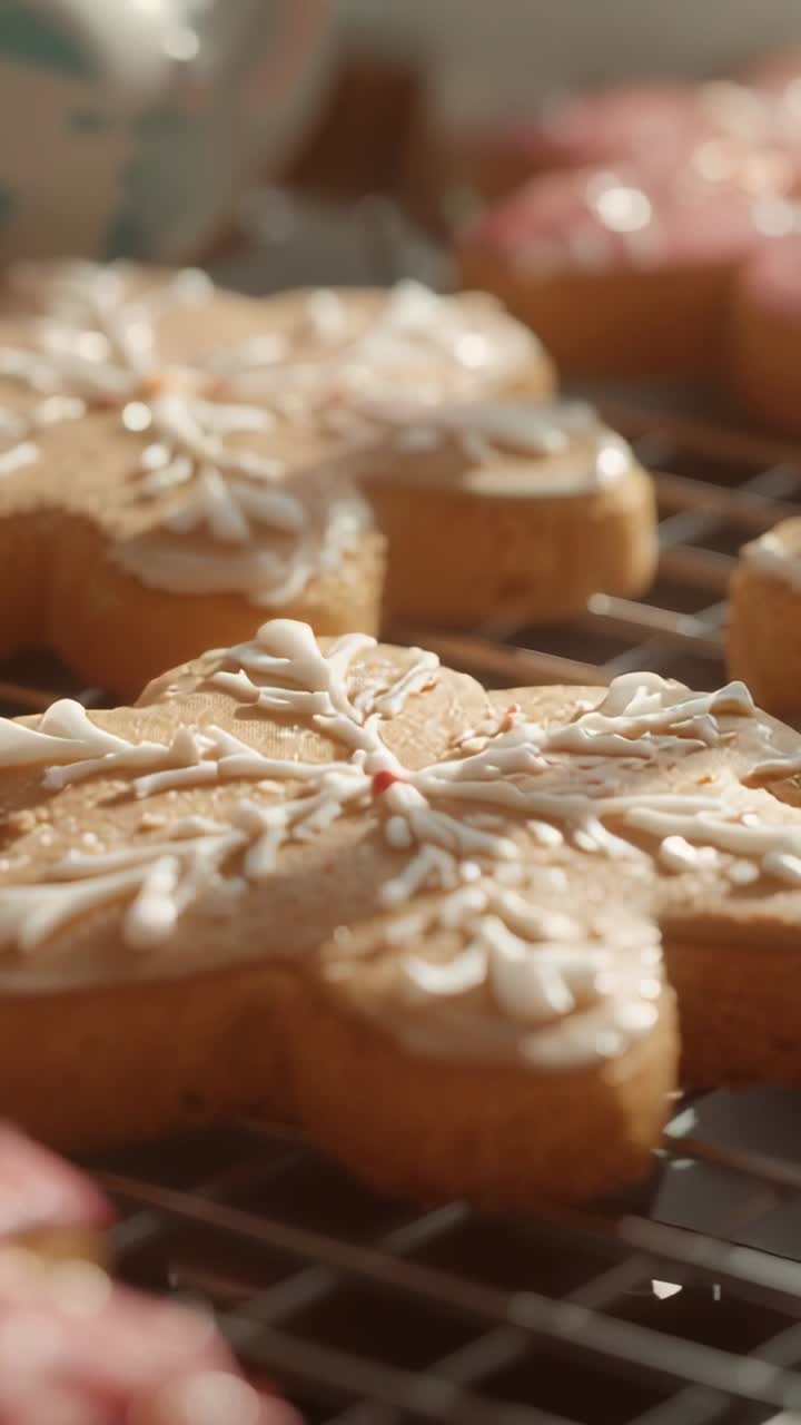 Vertical video: Shifting lens focus to snowflake cookie on rack blurring donut, mug behind