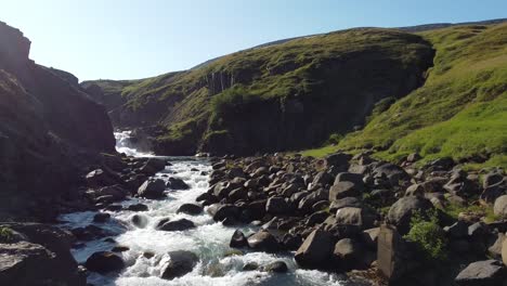 Rocky-landscape-and-powerful-mountain-river-in-Iceland,-aerial-drone-view