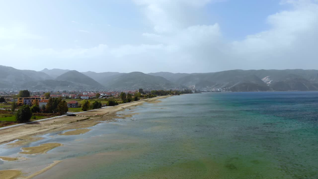 Beautiful lagoon with shallow water on Ohrid lake shoreline at a foggy morning