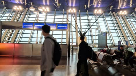 travelers waiting and walking in the terminal