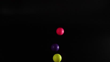 vibrant balls bouncing against a dark background