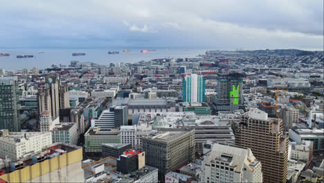 Cinematic-aerial-view-of-San-Francisco-South-Beach-neighbourhood,-South-Beach-harbour-with-container-ships-in-the-background,-CA,-USA