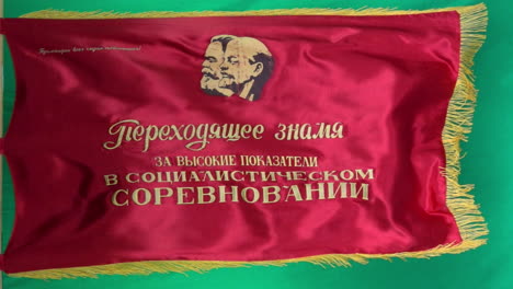 soviet flag depicting marx and lenin flies in slow motion against a green screen background