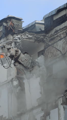 demolition of old residential building. destroying old house using bucket excavator on construction site