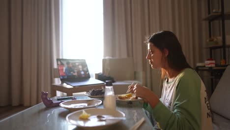 teenage girl eating breakfast while watching tv