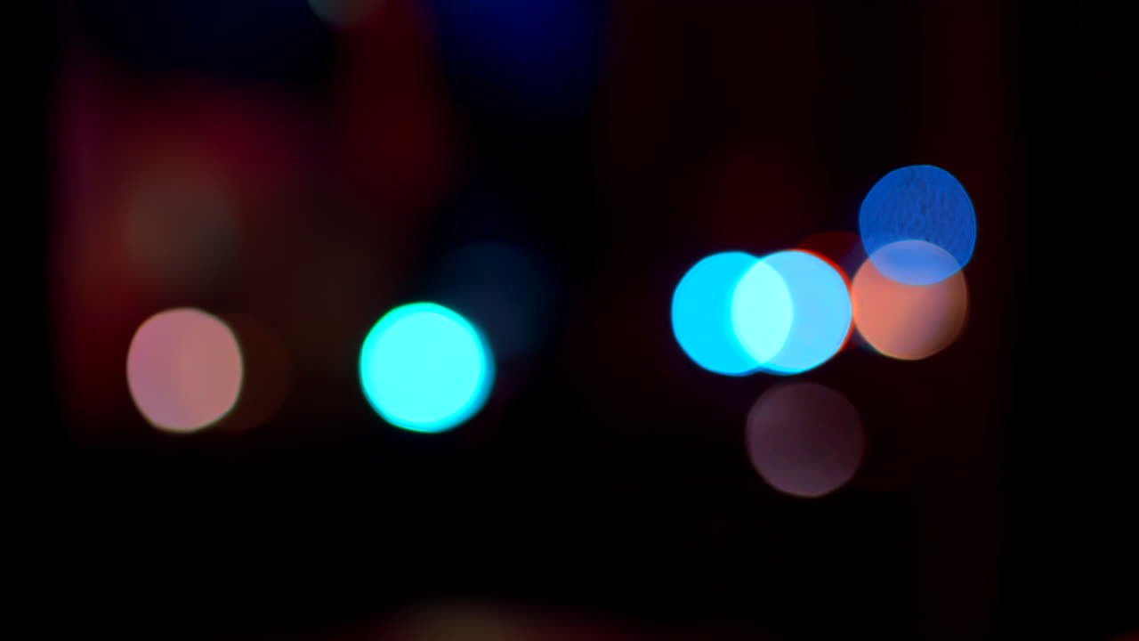 Abstract display of out-of-focus, colourful lights in a dark setting