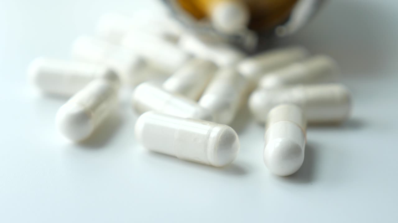 cápsulas blancas en una superficie blanca