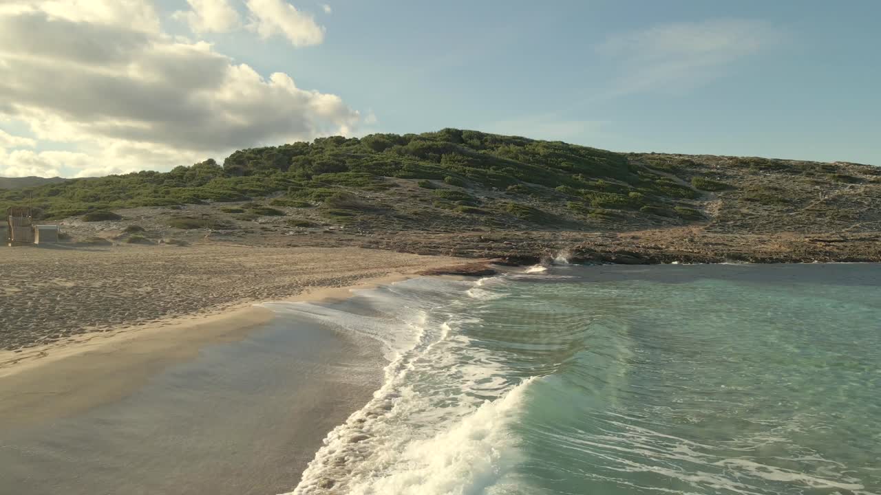 Explore the stunning beaches of Cala Torta and Cala Mesquida in Majorca, where gentle waves meet soft sands under a clear blue sky. Experience this picturesque coastal scene.