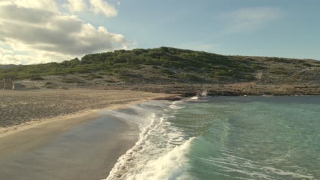 explore the stunning beaches of cala torta and cala mesquida in majorca, where gentle waves meet soft sands under a clear blue sky. experience this picturesque coastal scene.