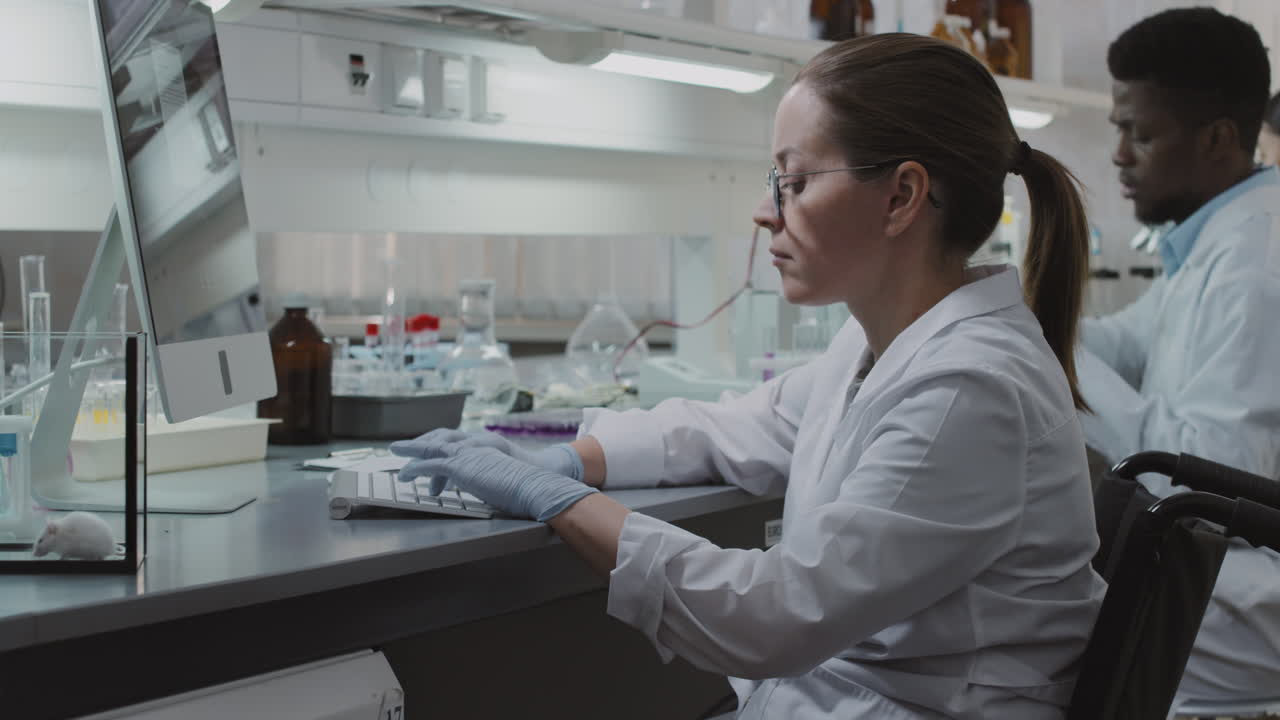 Disabled Female Scientist Working on Computer in Lab