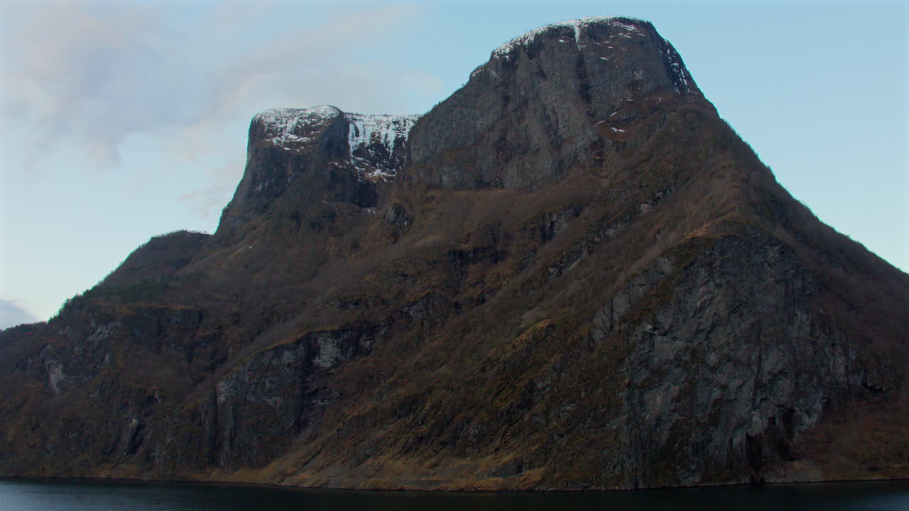 Slow wide tracking shot of the Lofti mountain in the Aurlandsfjorden, Sogneflord Fjords.