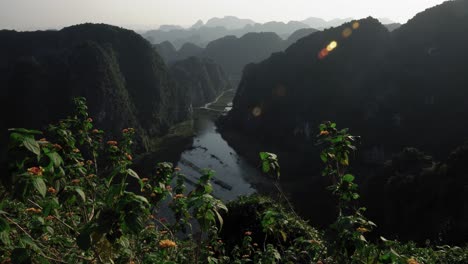 scenic river view from hang mua viewpoint with flowers in the foreground in 4k, ninh binh, vietnam