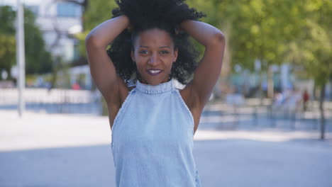 woman correcting hair, sending kisses, showing love sign