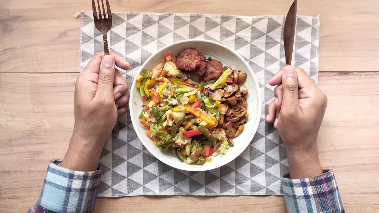 야채 가득한 접시에서 기다리고 포크로 젊은 남자