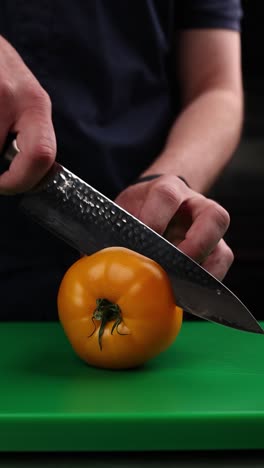 cutting a yellow tomato