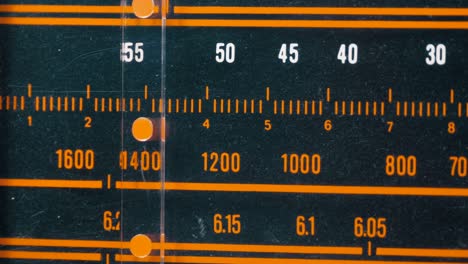 tuning analog radio dial frequency on scale of the vintage receiver